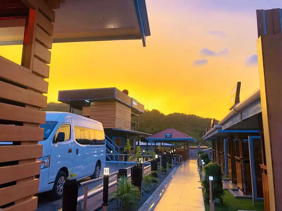 Bovotel hotel and vehicles in Arawa at sunset