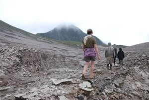 Hikers in the volcanic landscape approaching Mount Balbi