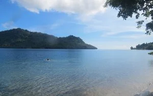 Blue water and forested shoreline at Pokpok Island